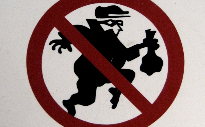 A sign of a thief with a no sign over it