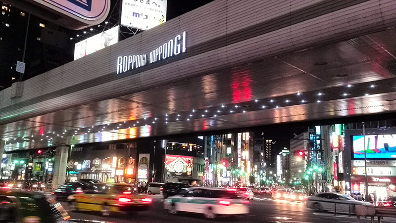 cars going through roppongi at night